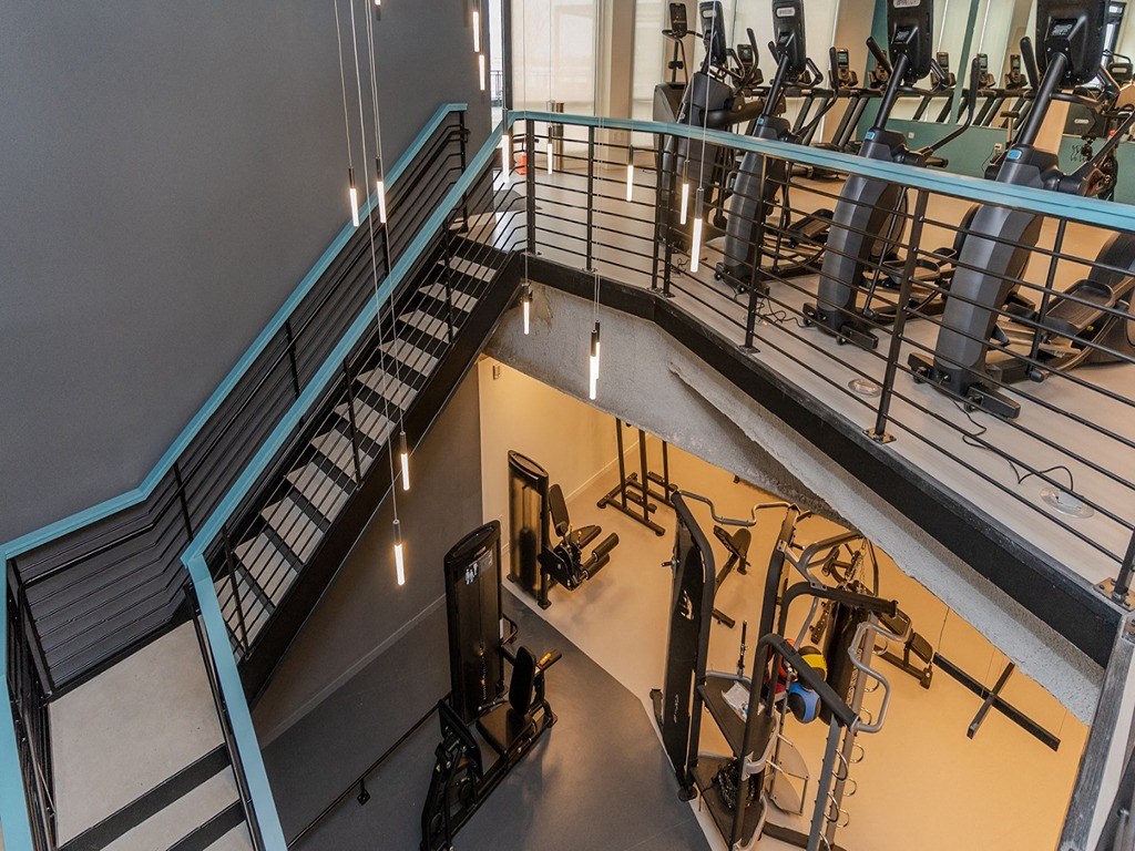 a gym with weights and cardio machines in a building